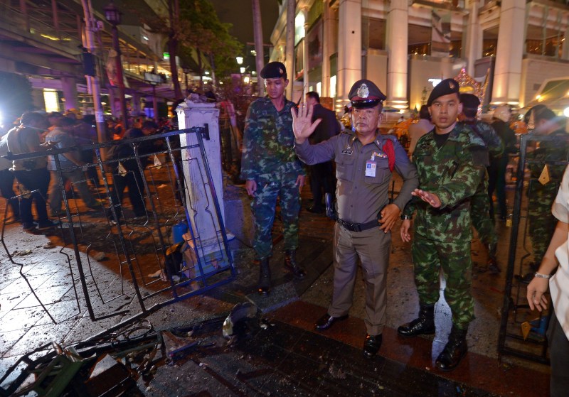 Thai soldiers and police stand guard after a bomb exploded outside a religious shrine in central Bangkok late on August 17, 2015 killing at least 10 people and wounding scores more. Body parts were scattered across the street after the explosion outside the Erawan Shrine in the downtown Chidlom district of the Thai capital.   AFP PHOTO / PORNCHAI KITTIWONGSAKUL        (Photo credit should read PORNCHAI KITTIWONGSAKUL/AFP/Getty Images)
